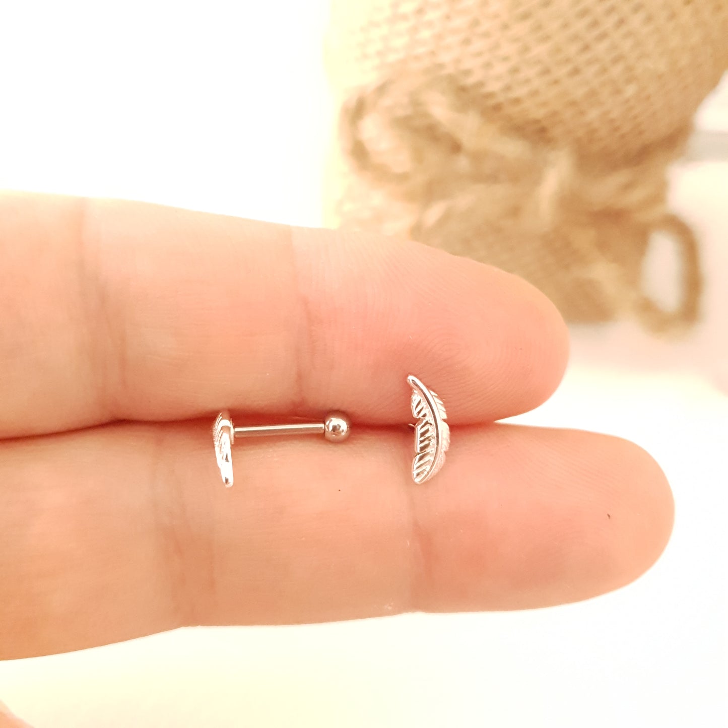 Tragus Piercing barbell with feather shaped top and a 3mm steel ball ( 316L surgical steel )