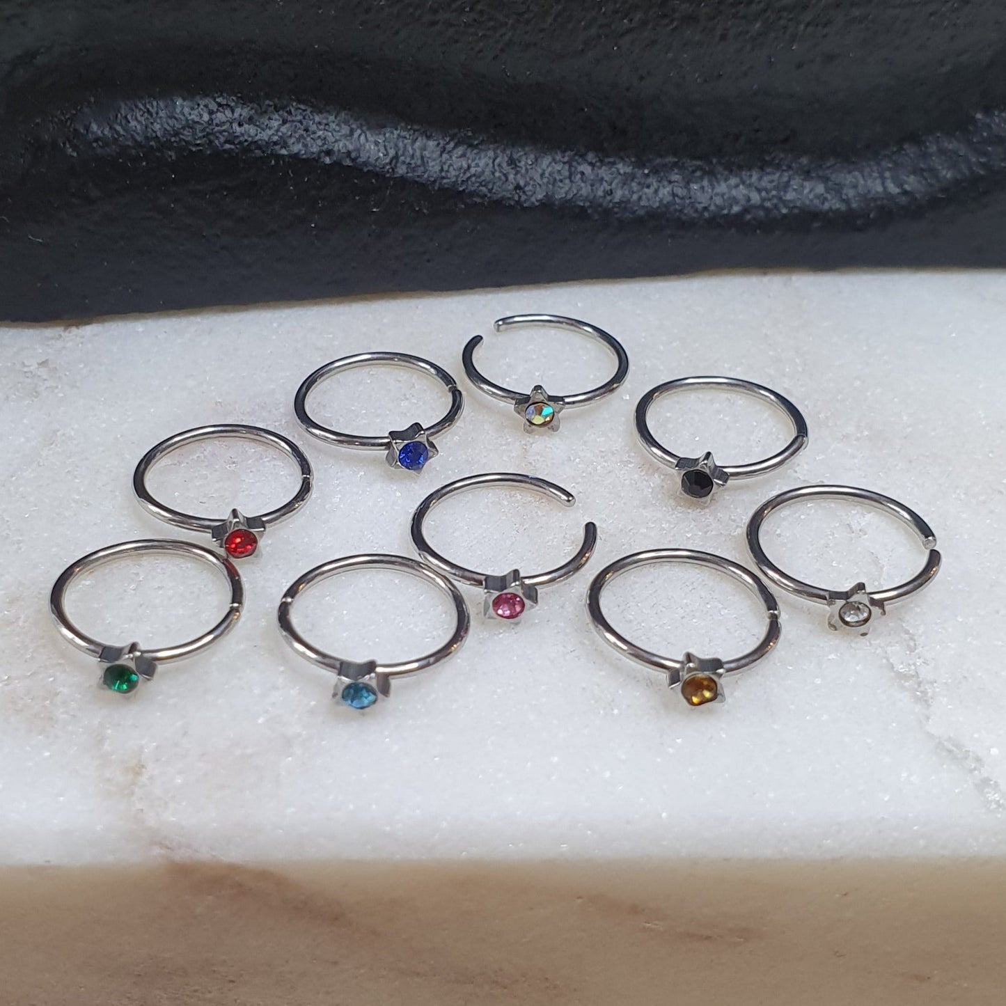 Continuous Ring with star shaped top and crystal ( surgical steel )