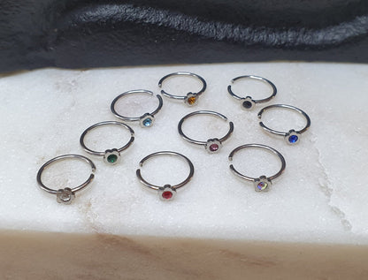 Continuous Ring with flower shaped top and crystal ( surgical steel  )