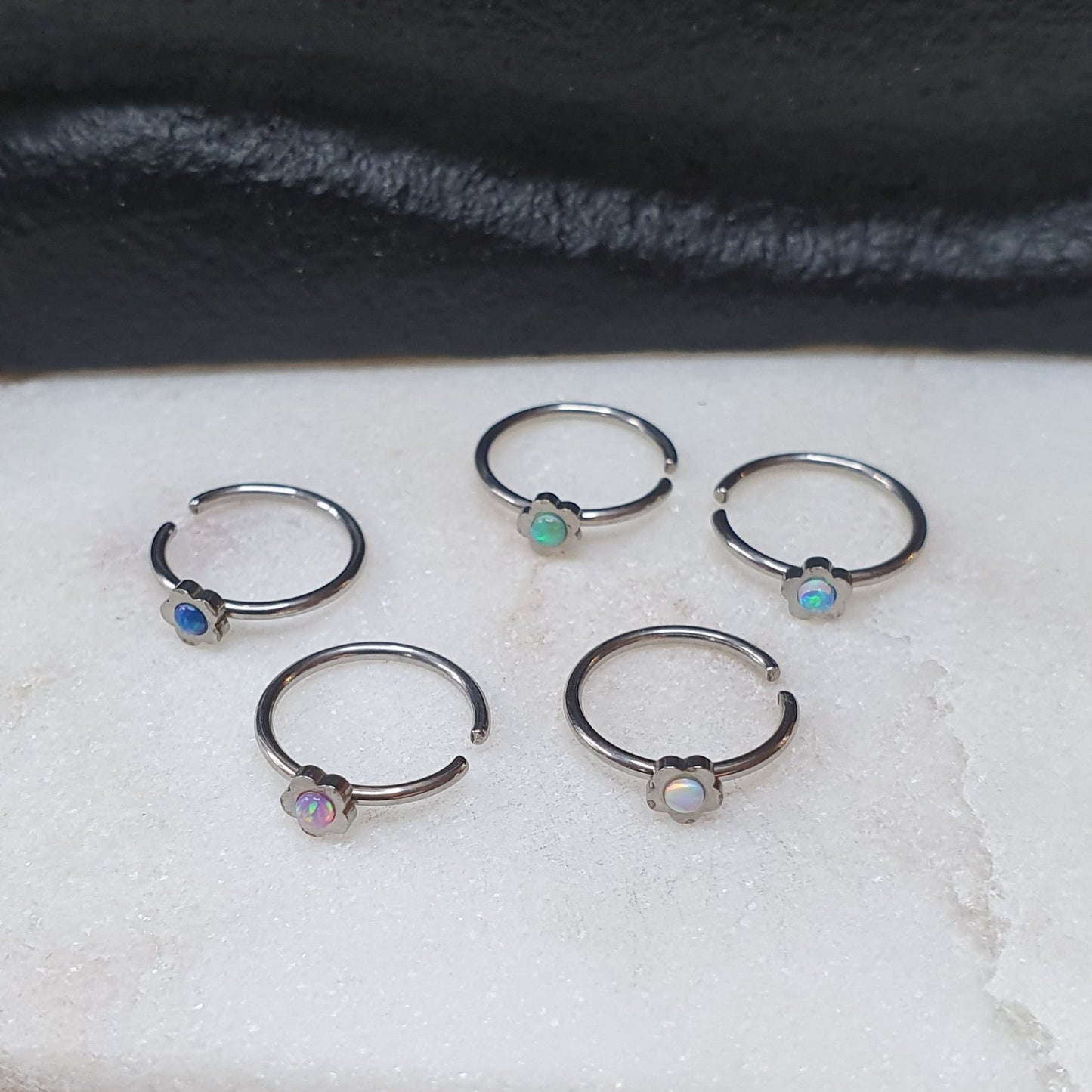 Continuous Ring with flower shaped top and synthetic opal ( surgical steel  )