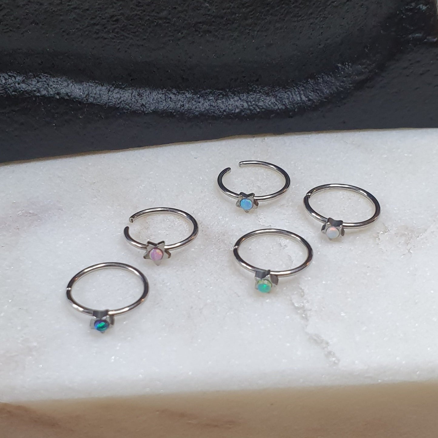 Continuous Ring with star shaped top and synthetic opal ( surgical steel  )