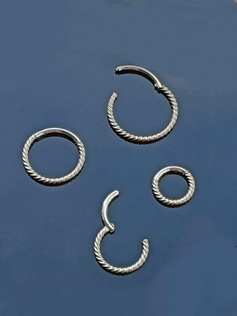 Piercing clicker hinged segment twisted wire ( surgical steel )