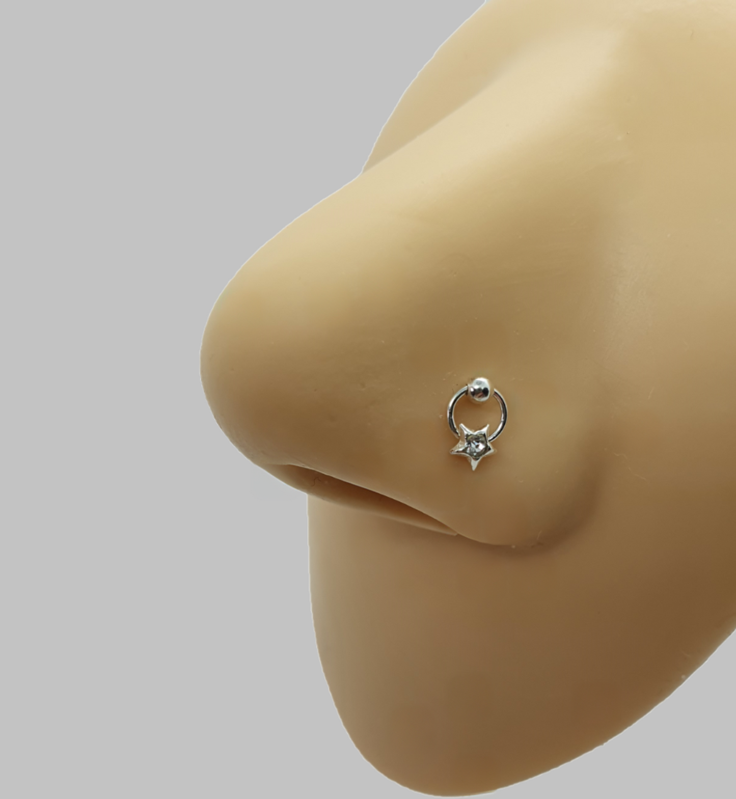Straight nose stud with a crystal on star shape slave hoop ( sterling silver )